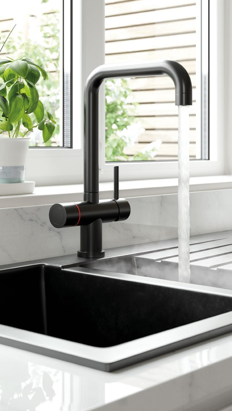 Matt black 3-in-1 boiling water tap over a black sink