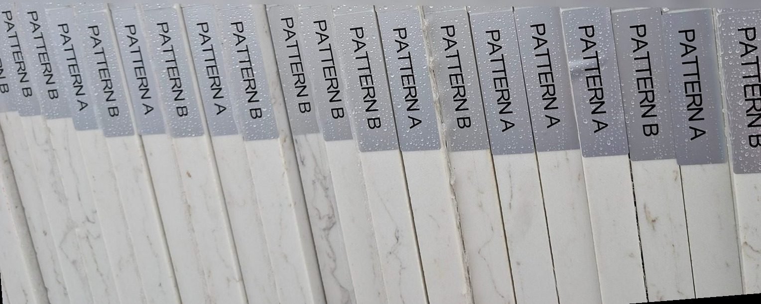 Row of quartz slab edges with silver labels reading Pattern A and Pattern B, marking bookmatched pairs